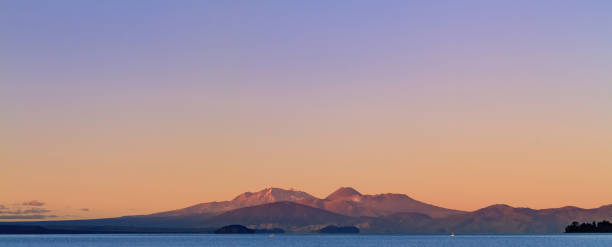 panoramic view over the Lake Taupo to the Tongariro-national park Panoramic view of lake Taupo looking at Mount Ngauruhoe and Mount Ruapehu of the Tongariro national park, new zealand. tongariro national park photos stock pictures, royalty-free photos & images