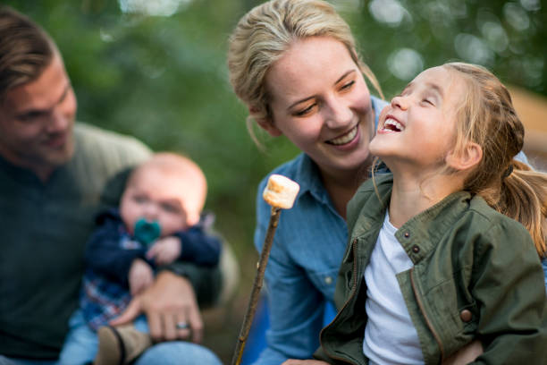 eating marshmallows - family white family with two children cheerful imagens e fotografias de stock