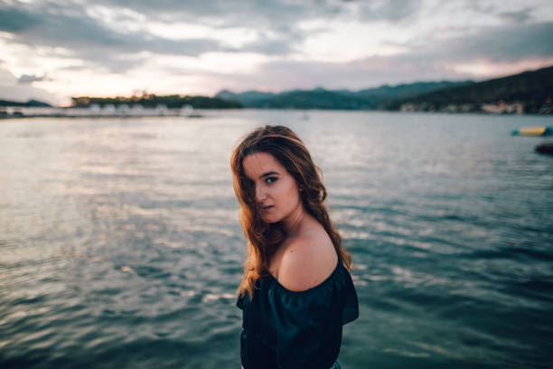 istock Young woman by the sea 860464942