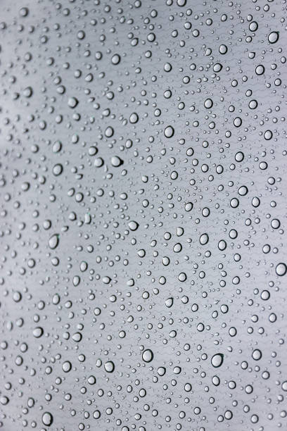 istock Rain drops on car windows. Gray background, vertical photo 860474934