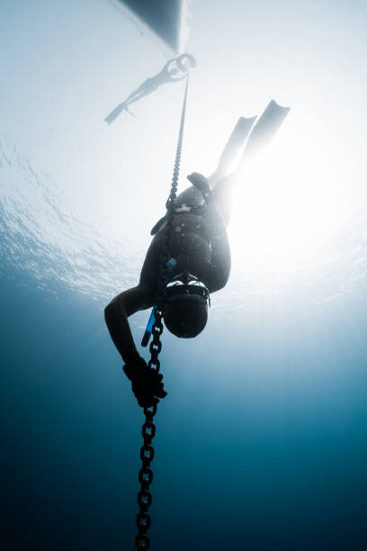 istock Freediver descending to the depth 860475124