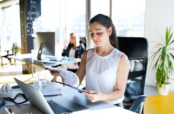 istock Two business women in the office working. 860475472