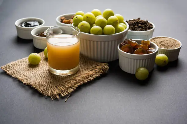 Stock photo of Amla/Avla/Aavla and it's by products like chyawanprash or chyavanprash, juice, Amla supari or mouth freshner, powder, juicy or dried sweet murabba or muramba, pickle, selective focus