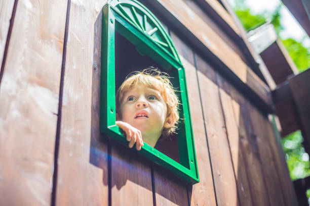 istock Cute little boy is playing on a wooden playground 860479532