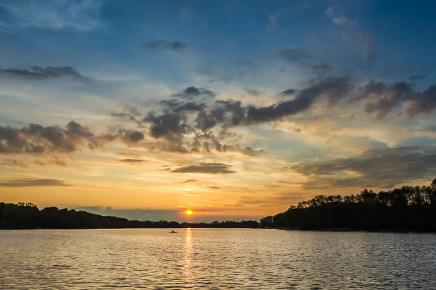 istock Stunning sunset at the lake with alone boat in summer 860483858
