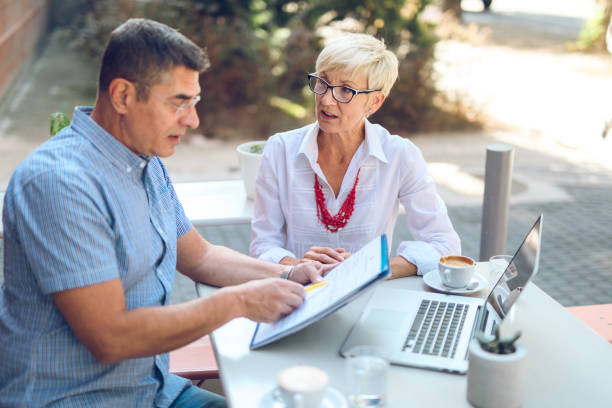 istock Two casual business people discussing business issues in cafe 860484144