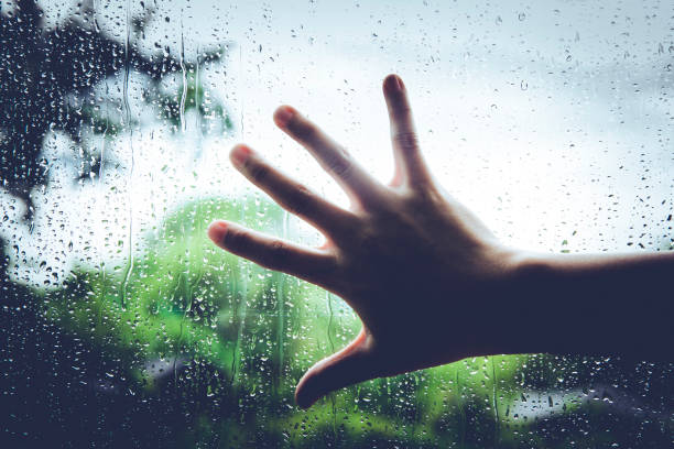 istock Rainy mood. Some person touching the window while raining day. 860484556