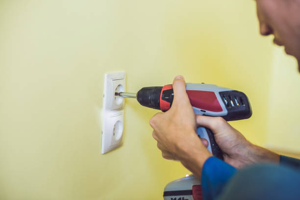 istock Electrician Installing Socket In New House 860484658