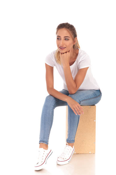 istock smiling young blonde woman sitting and thinking 860484752