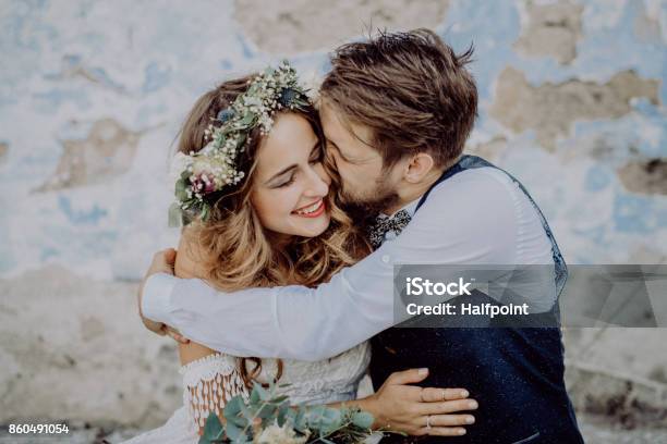 Beautiful Bride And Groom In Front Of Old Shabby House Stock Photo - Download Image Now