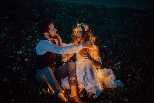 istock Beautiful bride and groom on a meadow at night. 860491336