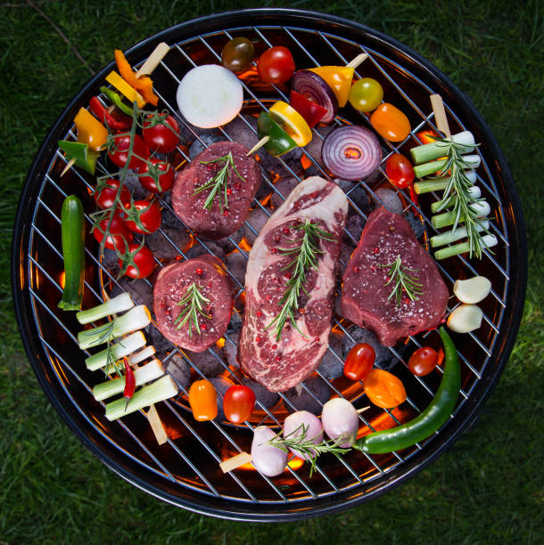 Assorted delicious beef meat with vegetable on a barbecue grill.