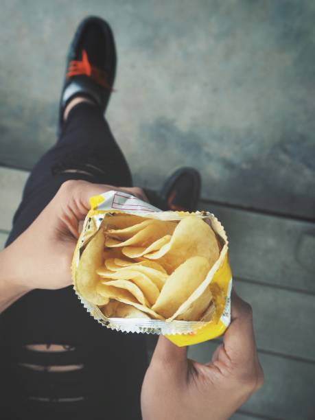 istock Woman eating potato chip 860492724