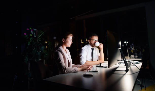 istock Businesspeople in the office at night working late. 860503004
