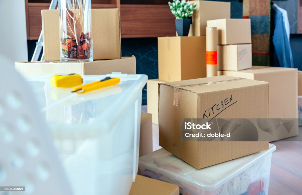 Living room with moving boxes Large living room with stack of moving boxes Packing Stock Photo