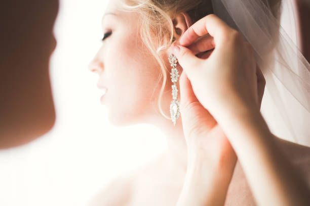 istock Luxury bride in white dress posing while preparing for the wedding ceremony 860507598