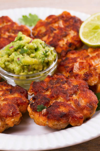 istock Salmon burgers with avocado salsa. Salmon cakes 860507686