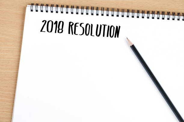 istock 2018 resolution on blank paper notebook background, with copy space for text, business background concept 860509508
