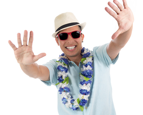 Party boy takes advantage of the carnival spirit. Young latin american man wearing blue shirt. Isolated on white background.