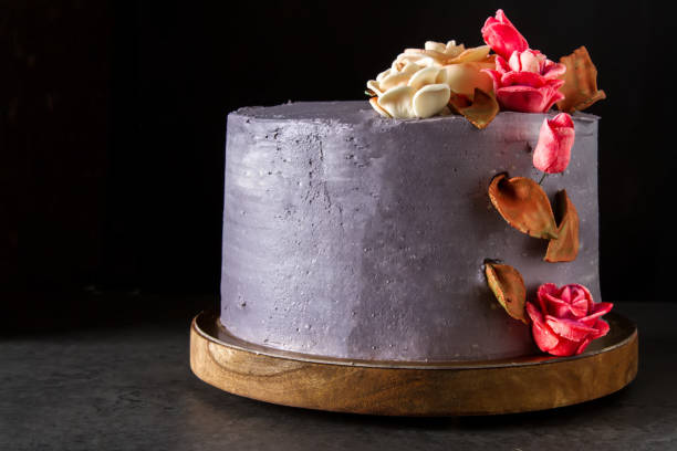 istock Chocolate cake with flowers for birthday. Dark background. 860515650