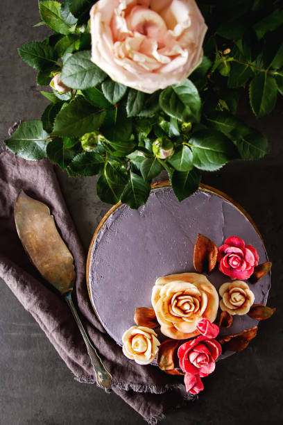 istock Chocolate cake with flowers for birthday. Dark background. 860515728