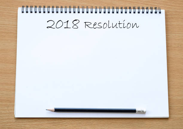 istock 2018 resolution on blank paper notebook background, with copy space for text, business background concept 860516484