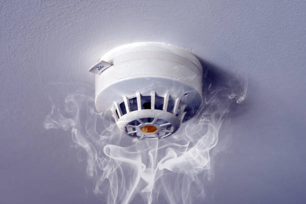 istock Fire alarm with smoke and copy space 860528216