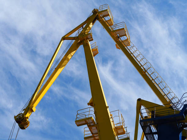 istock yellow harbor crane against the blue sky, bottom view 860528912