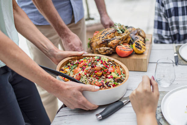 istock Midsection of friends with food at dining table 860533800