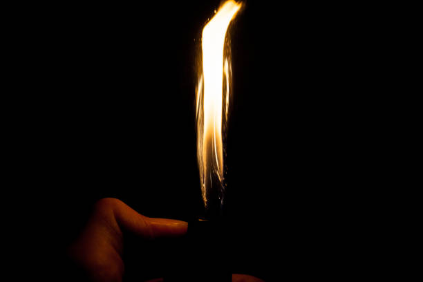 istock Close up view of real sparking light from lighter in dark black background 860534190