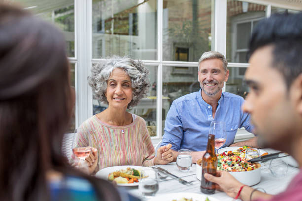 istock Happy friends having lunch in backyard 860534254