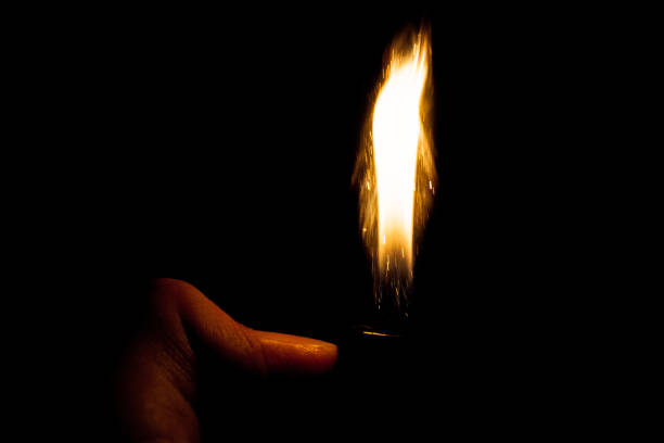 istock Close up view of real sparking light from lighter in dark black background 860534298