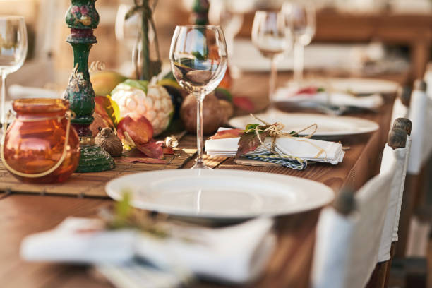 Ready to serve lunch Shot of a nicely set diner table with different kinds of plates and glasses on it holiday event stock pictures, royalty-free photos & images