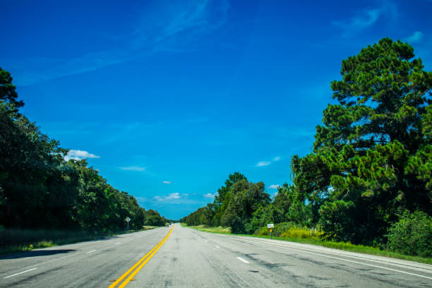 Open road driving across east Texas from Houston to Austin , Texas in the middle of no where sunny day blue sky and open highway freedom of the road