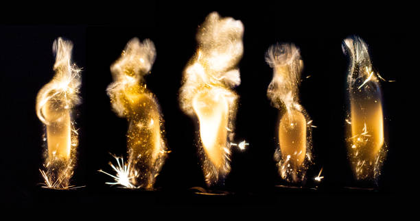 Close up view of real sparking light from lighter in dark black background