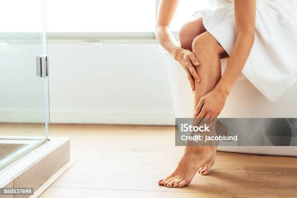 Woman Taking Care Of Her Body After Bath Stock Photo - Download Image Now - Leg, Moisturizer, Applying