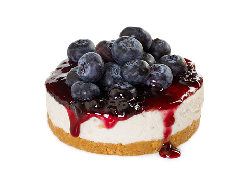 Cheesecake with fresh blueberries isolated on white background.