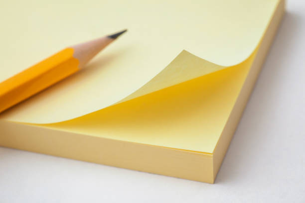 istock yellow sticky note paper and pencil on white backgrounds 860541842