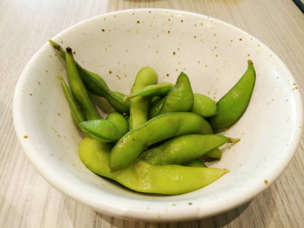 istock Green soybeans edamame japanese snack on plate on table 860545544