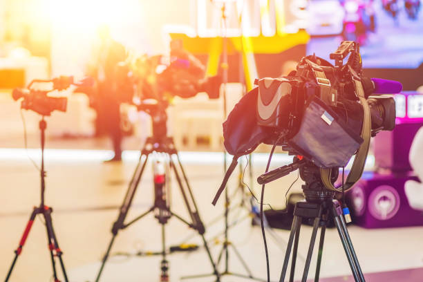 istock TV NEWS studio with camera and lights 860548866