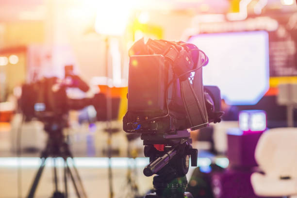 istock TV NEWS studio with camera and lights 860548874