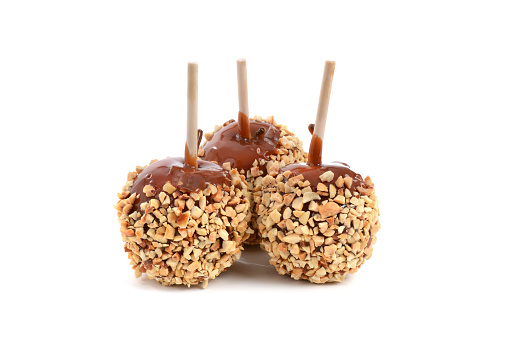 three caramel apples isolated on a white background