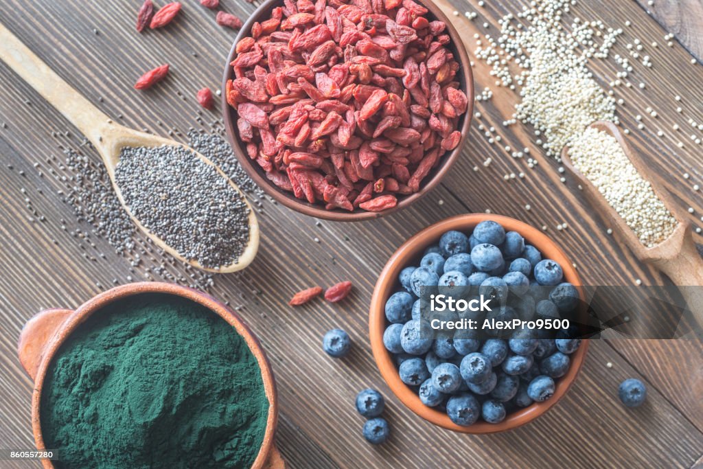 Superfoods on the wooden table Bowls of superfoods on the wooden background: top view Antioxidant Stock Photo