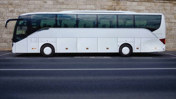 istock White tourist bus parked on empty road 860562236