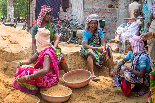 Bargarh, Odisha, India - April 08, 2015: Indian woman labourers. It is common place in India to find women from the poorer castes working as labourers on construction sites. These women were working as a group of all female labourers in construction of a farm bunglow.