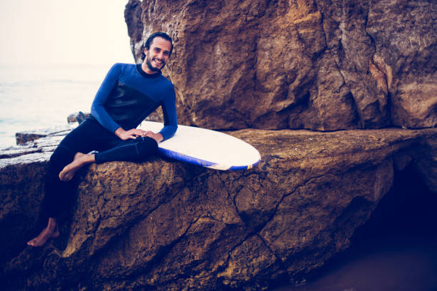 istock Surfer relaxing on the rock 860565742