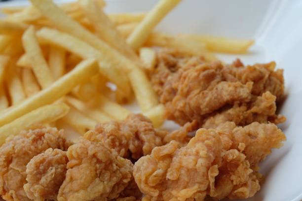 istock fried chicken with french fries 860566104