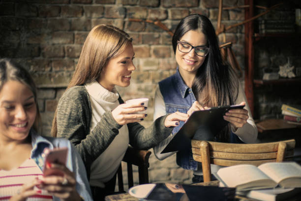 istock Three students girls in cafe. 860568338