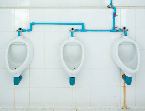 Dirty urinal row with the stain. Dirty urinal row with the stain in the public toilet of the Thai temple. flushing valve public restroom toilet stock pictures, royalty-free photos & images