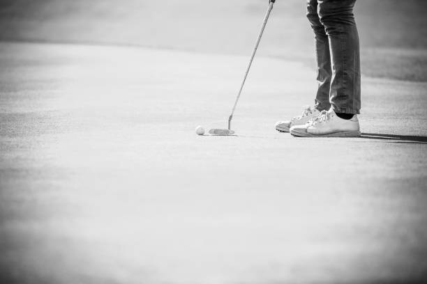 istock Golfer putting a ball on a golf course green 860574254